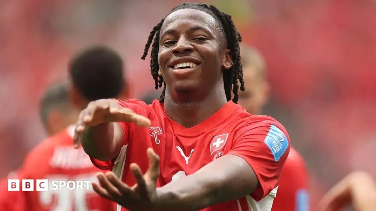 Player celebrating during a match in red jersey Player celebrating during a match in red jersey