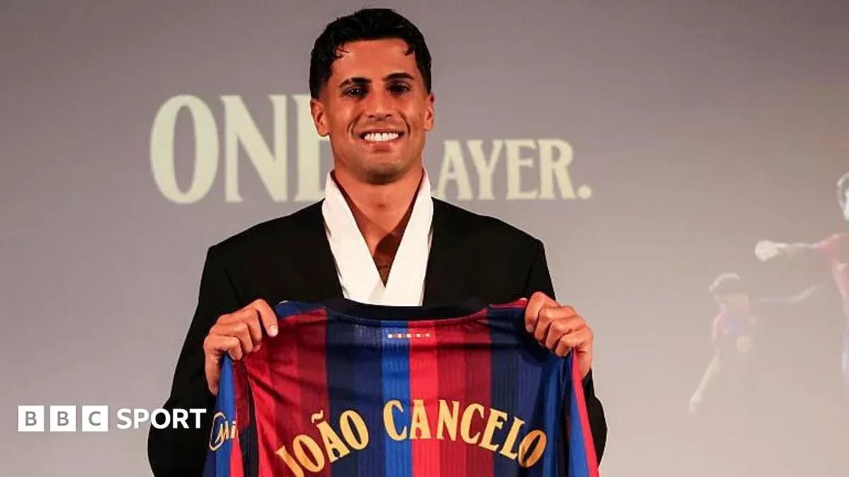 Player holding FC Barcelona jersey at presentation event Player holding FC Barcelona jersey at presentation event