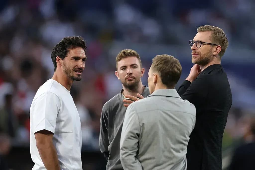 Four men discussing on the sidelines of a match Four men discussing on the sidelines of a match