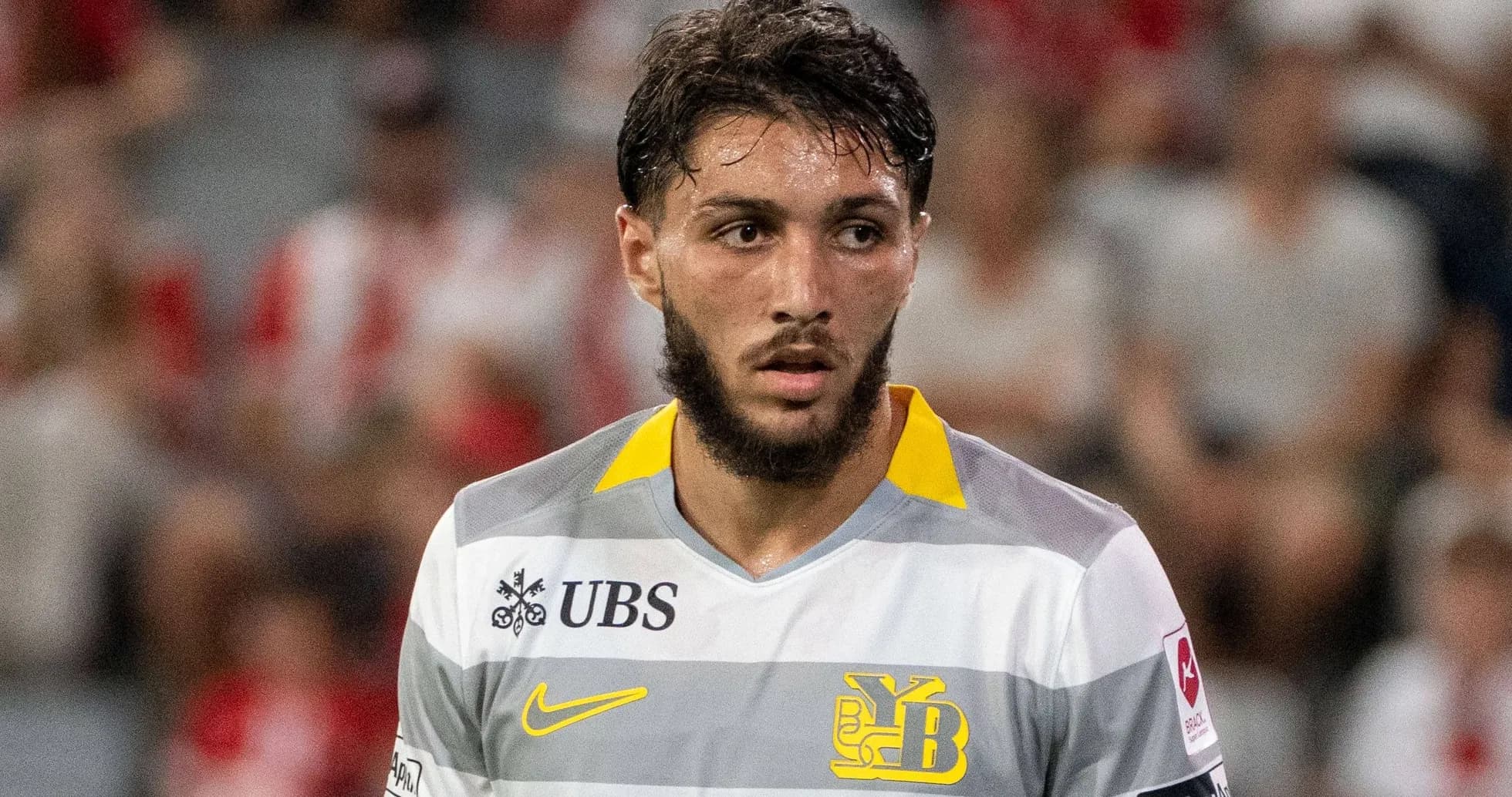 Player in yellow and gray jersey during match Player in yellow and gray jersey during match