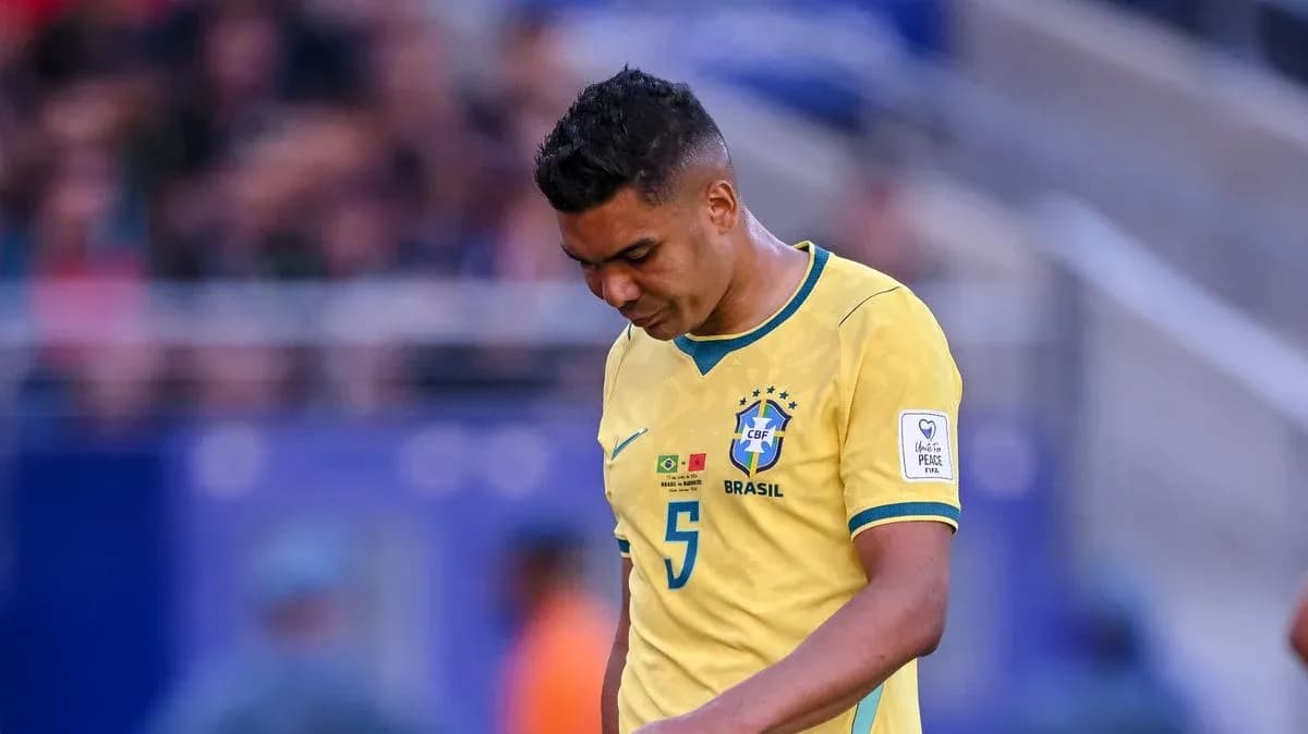 Brazilian player walking with head down on field Brazilian player walking with head down on field