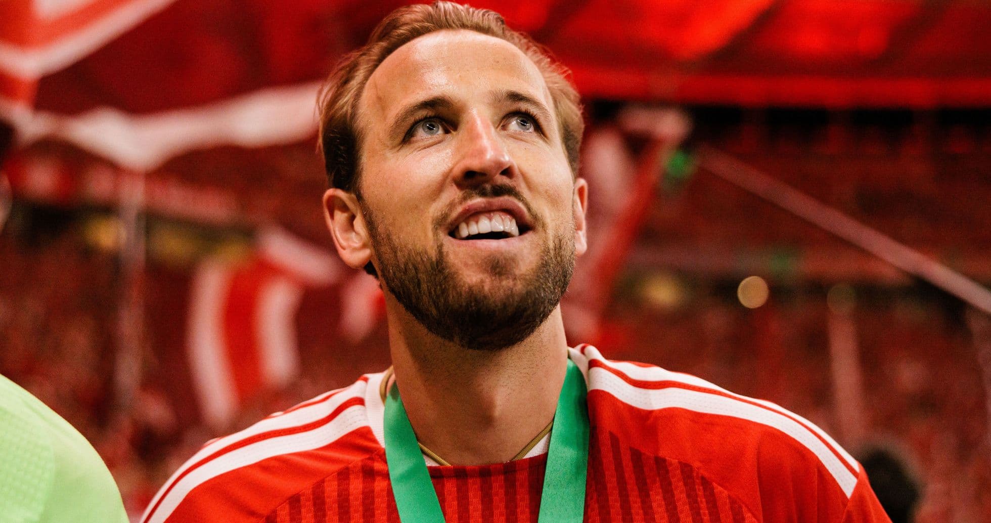 Player celebrating with medal and red background Player celebrating with medal and red background
