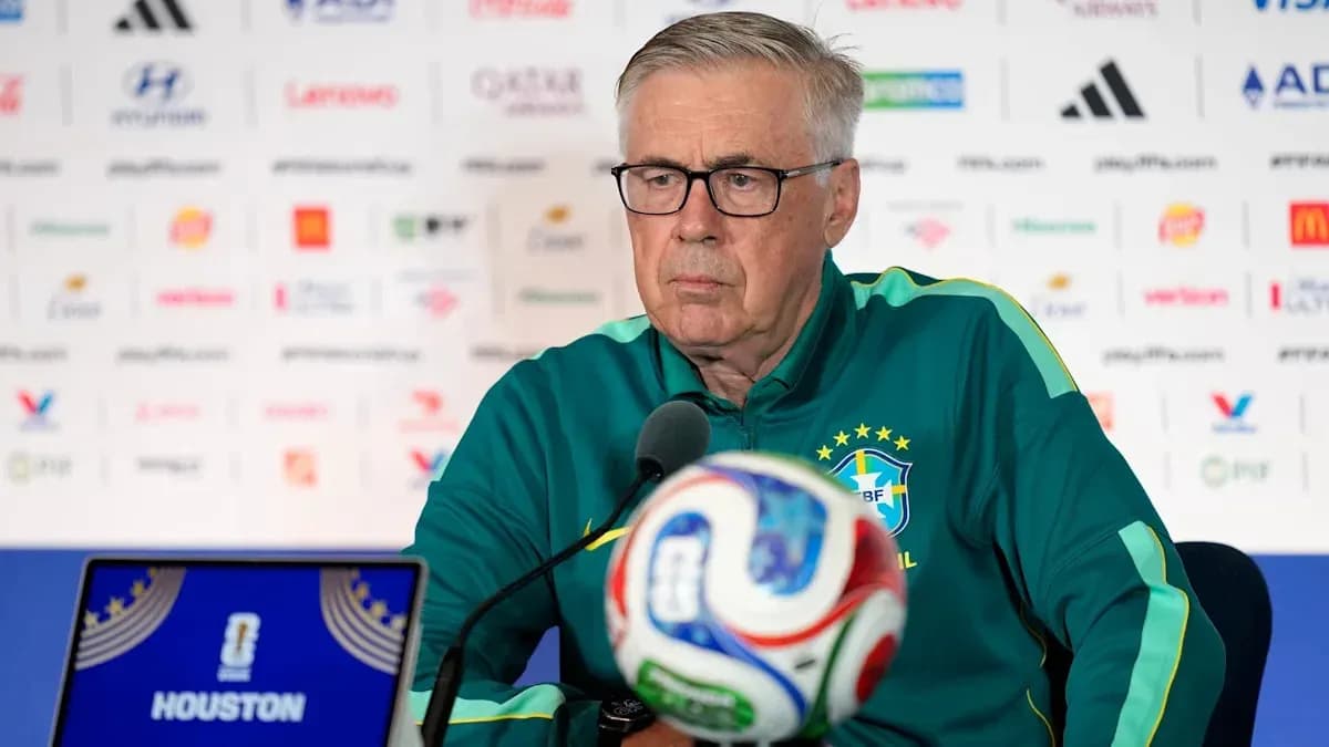 Coach at press conference with soccer ball in foreground Coach at press conference with soccer ball in foreground