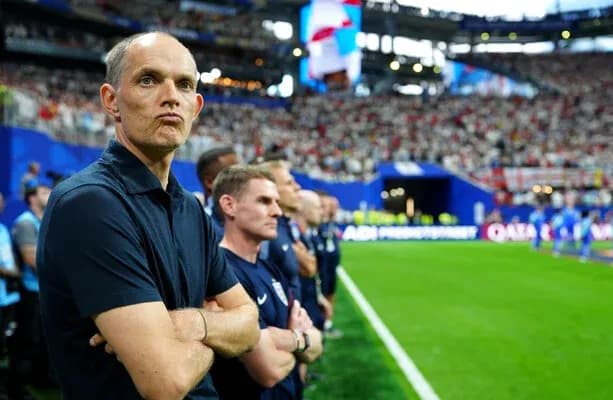 Coach observing match from sidelines with staff Coach observing match from sidelines with staff