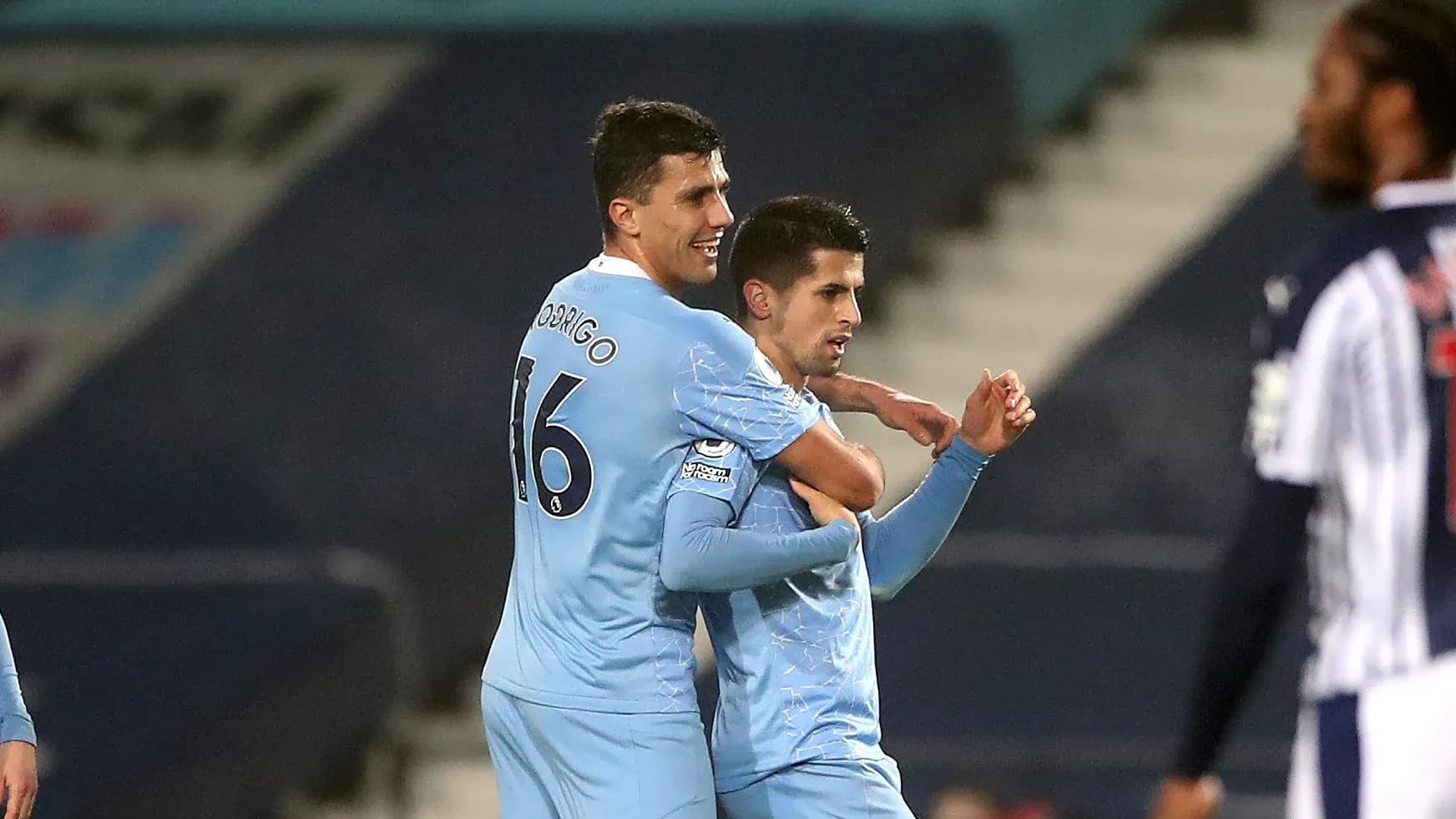 Two players celebrating a goal on the pitch Two players celebrating a goal on the pitch