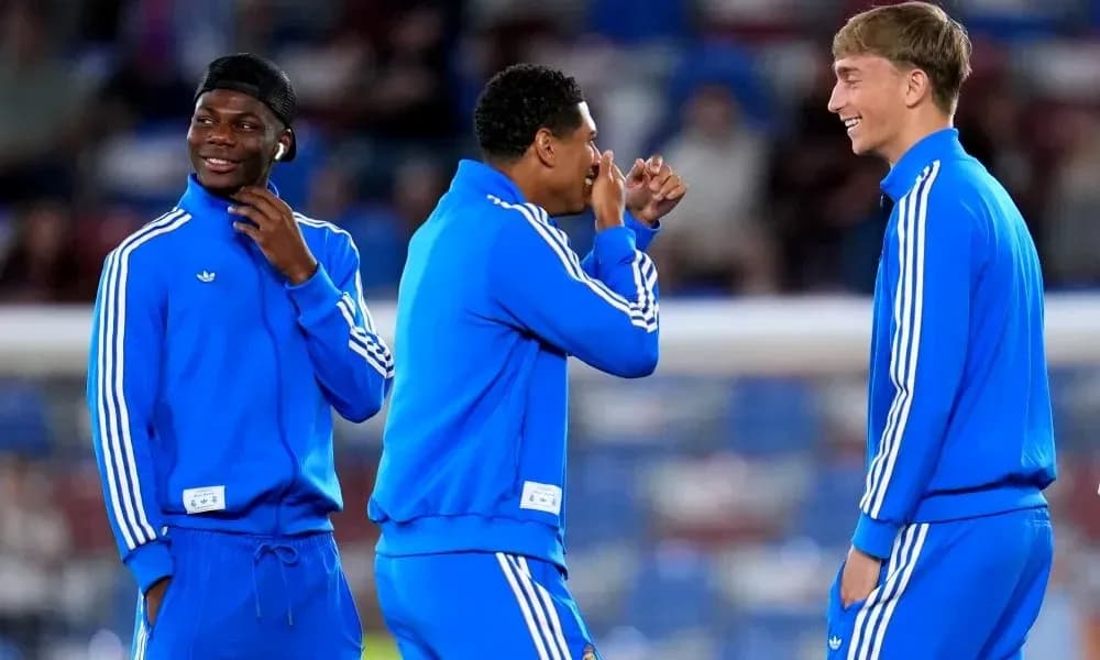 Three players in blue training gear laughing together Three players in blue training gear laughing together
