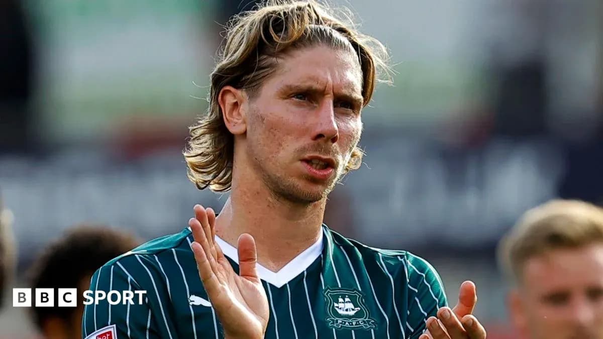 Player applauding fans after match wearing team jersey Player applauding fans after match wearing team jersey