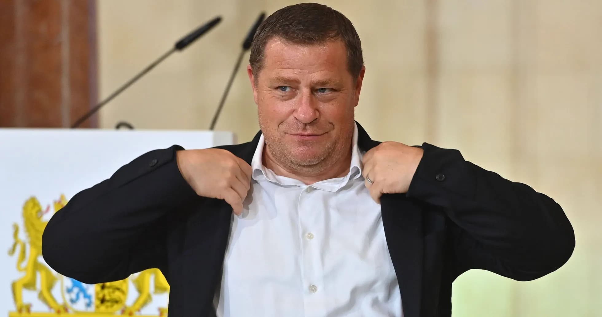 Man adjusting his jacket during a presentation Man adjusting his jacket during a presentation