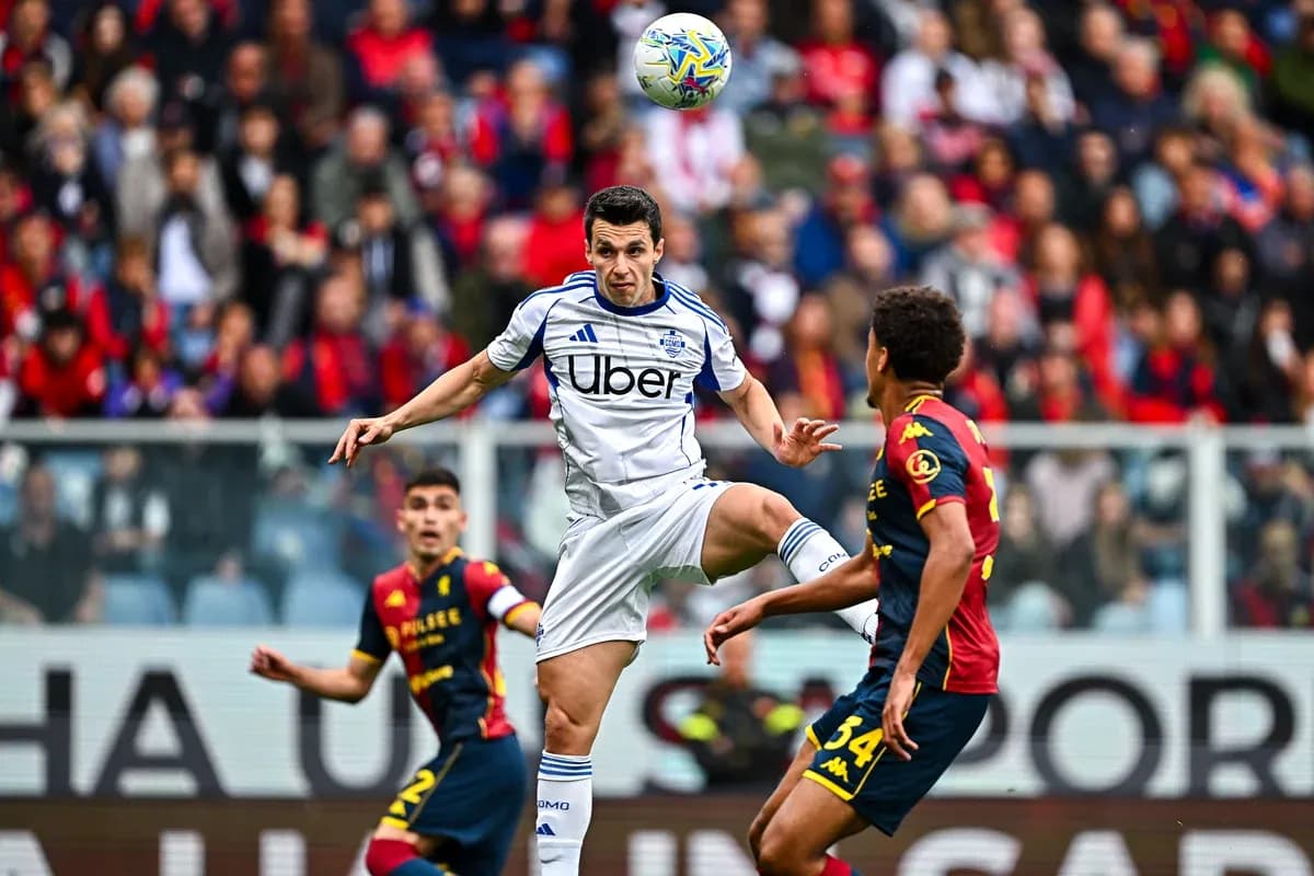 Genoa player challenging Como player for the ball Genoa player challenging Como player for the ball