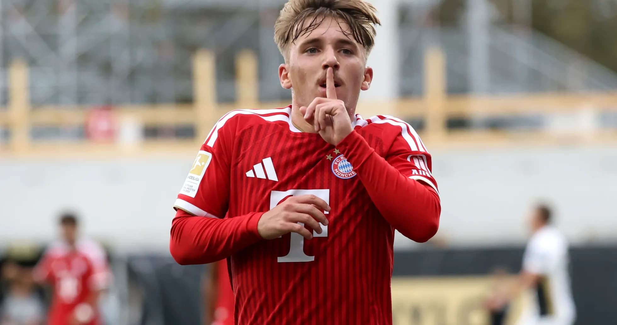 Player celebrating with shushing gesture in red jersey Player celebrating with shushing gesture in red jersey