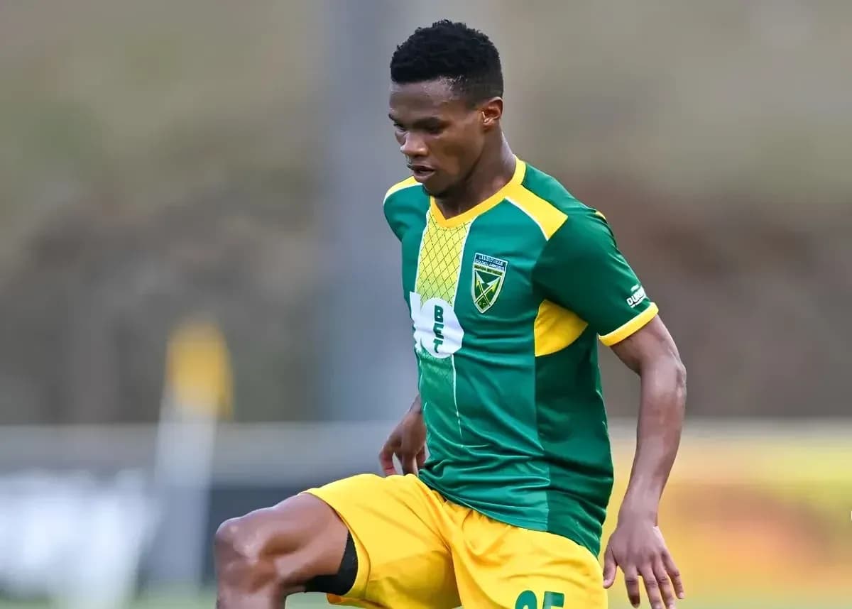 Player in green and yellow kit during match action Player in green and yellow kit during match action