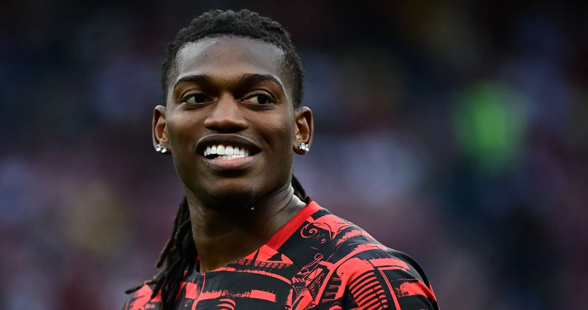 Player smiling in a red patterned jersey Player smiling in a red patterned jersey