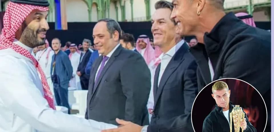 Men shaking hands at an event with audience in background Men shaking hands at an event with audience in background