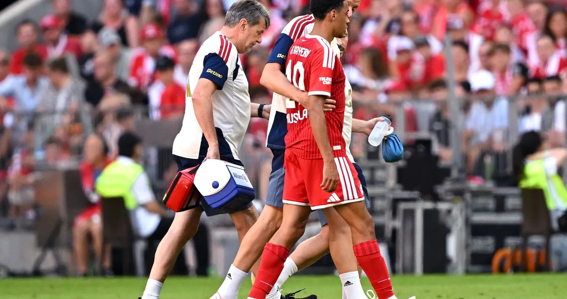 Player receiving medical assistance off the field Player receiving medical assistance off the field