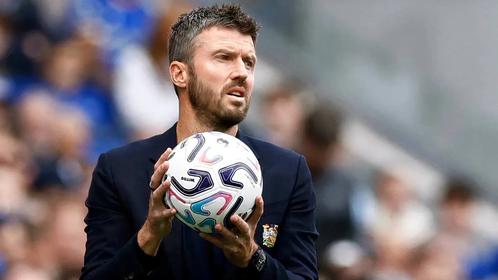 Coach holding ball during match on sideline Coach holding ball during match on sideline