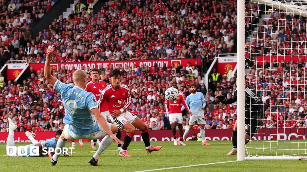 Player striking ball in Manchester derby match Player striking ball in Manchester derby match