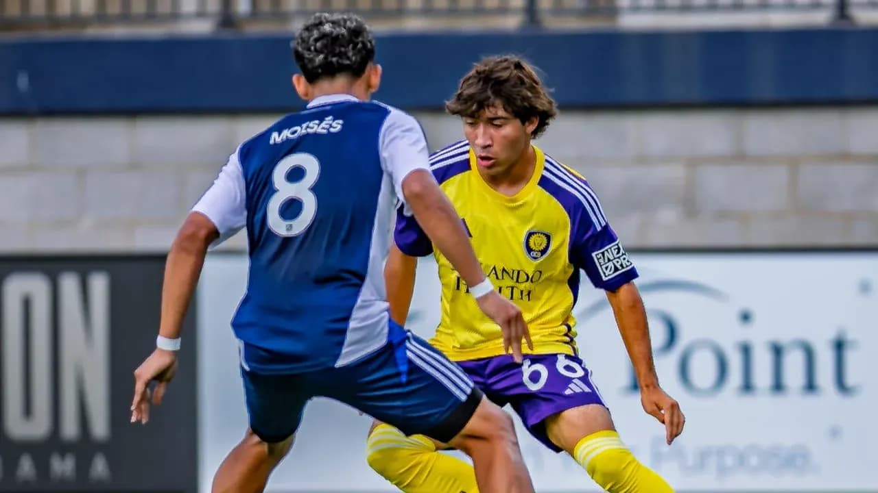 Two players competing for the ball in match Two players competing for the ball in match