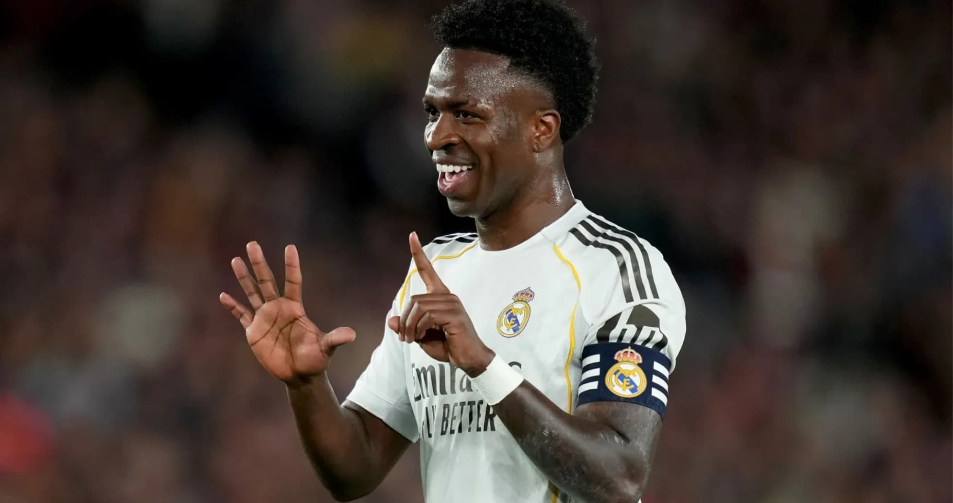 Player celebrating with fingers raised on pitch Player celebrating with fingers raised on pitch