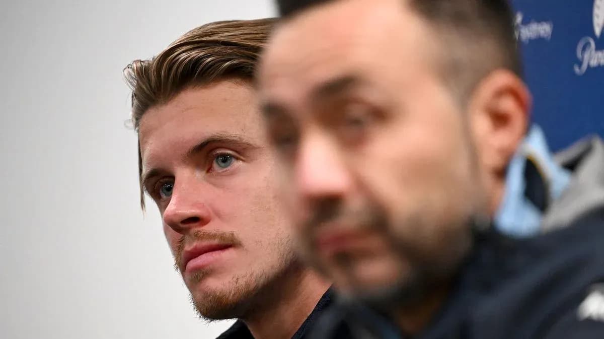 Two men at press conference, one in focus Two men at press conference, one in focus