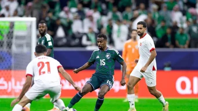 Saudi player dribbling past opponents during match Saudi player dribbling past opponents during match