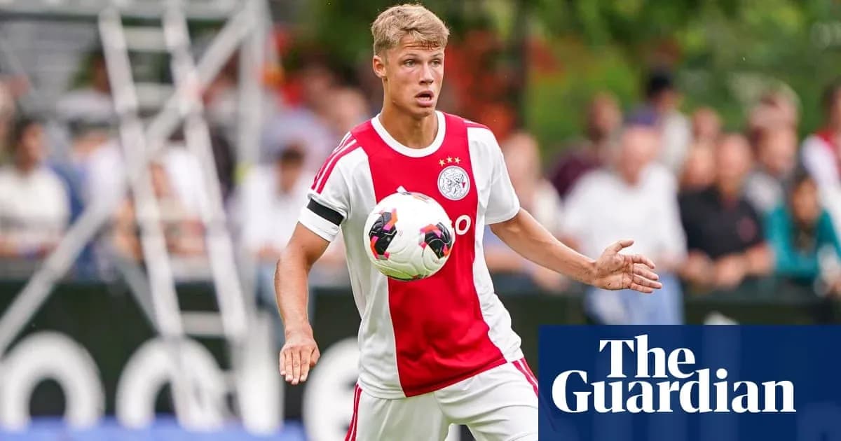 Player in Ajax kit controlling a soccer ball Player in Ajax kit controlling a soccer ball