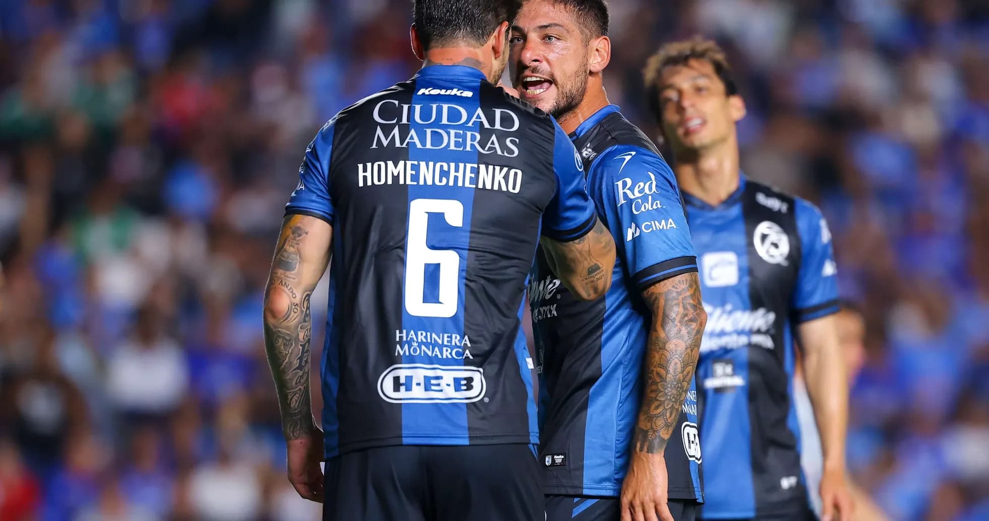 Players discussing strategy during Liga MX match Players discussing strategy during Liga MX match