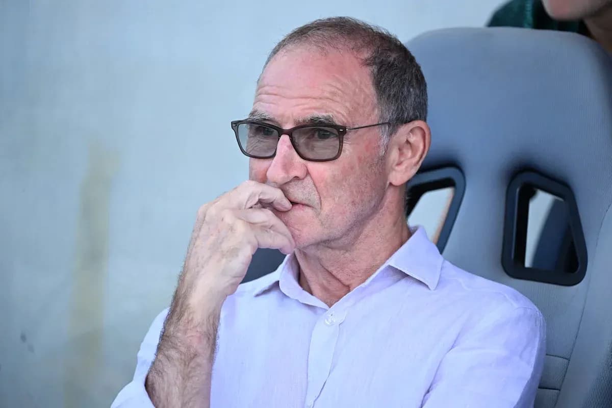 Man in glasses seated on bench during match Man in glasses seated on bench during match