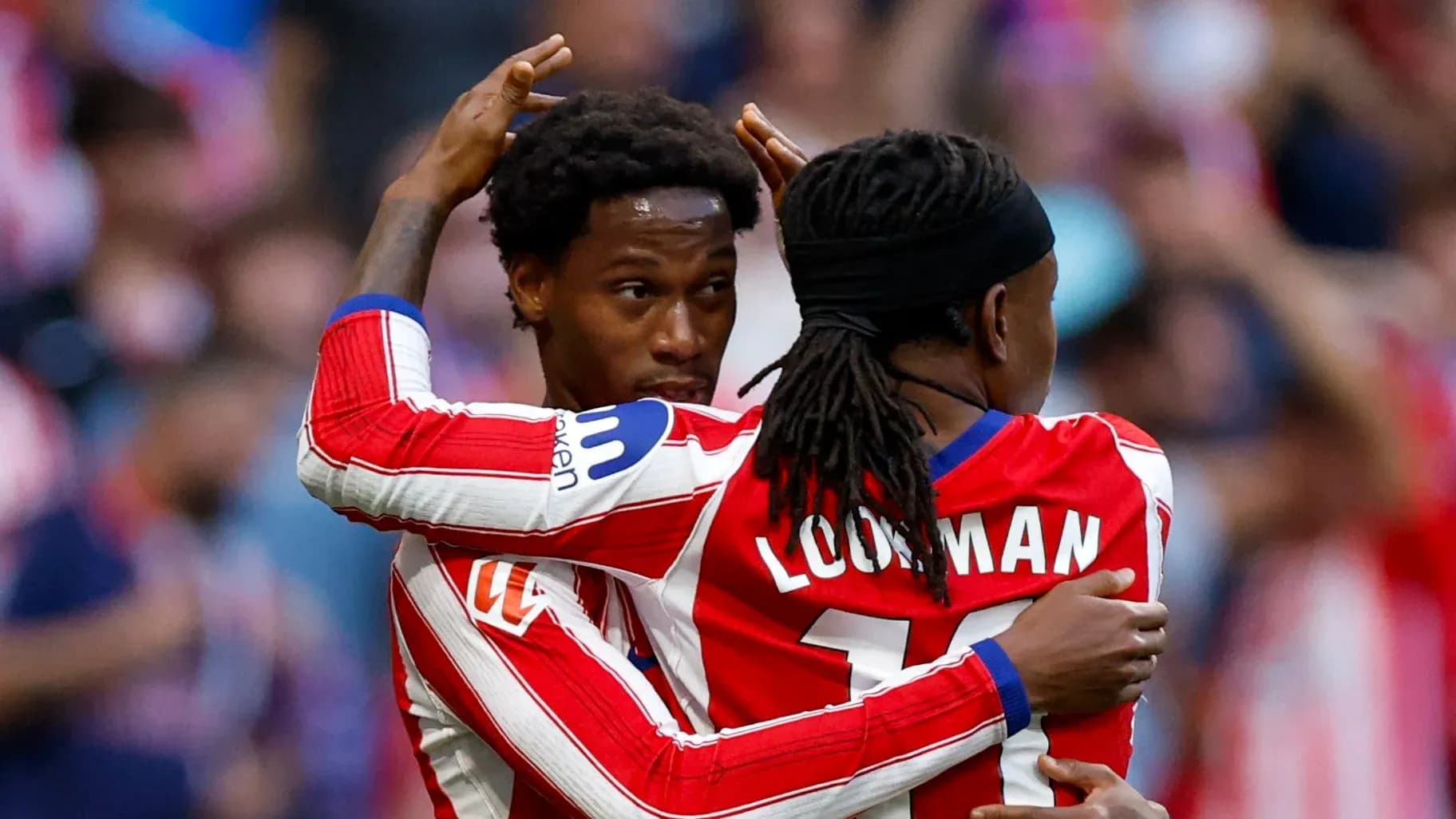 Two players celebrating a goal together on field Two players celebrating a goal together on field