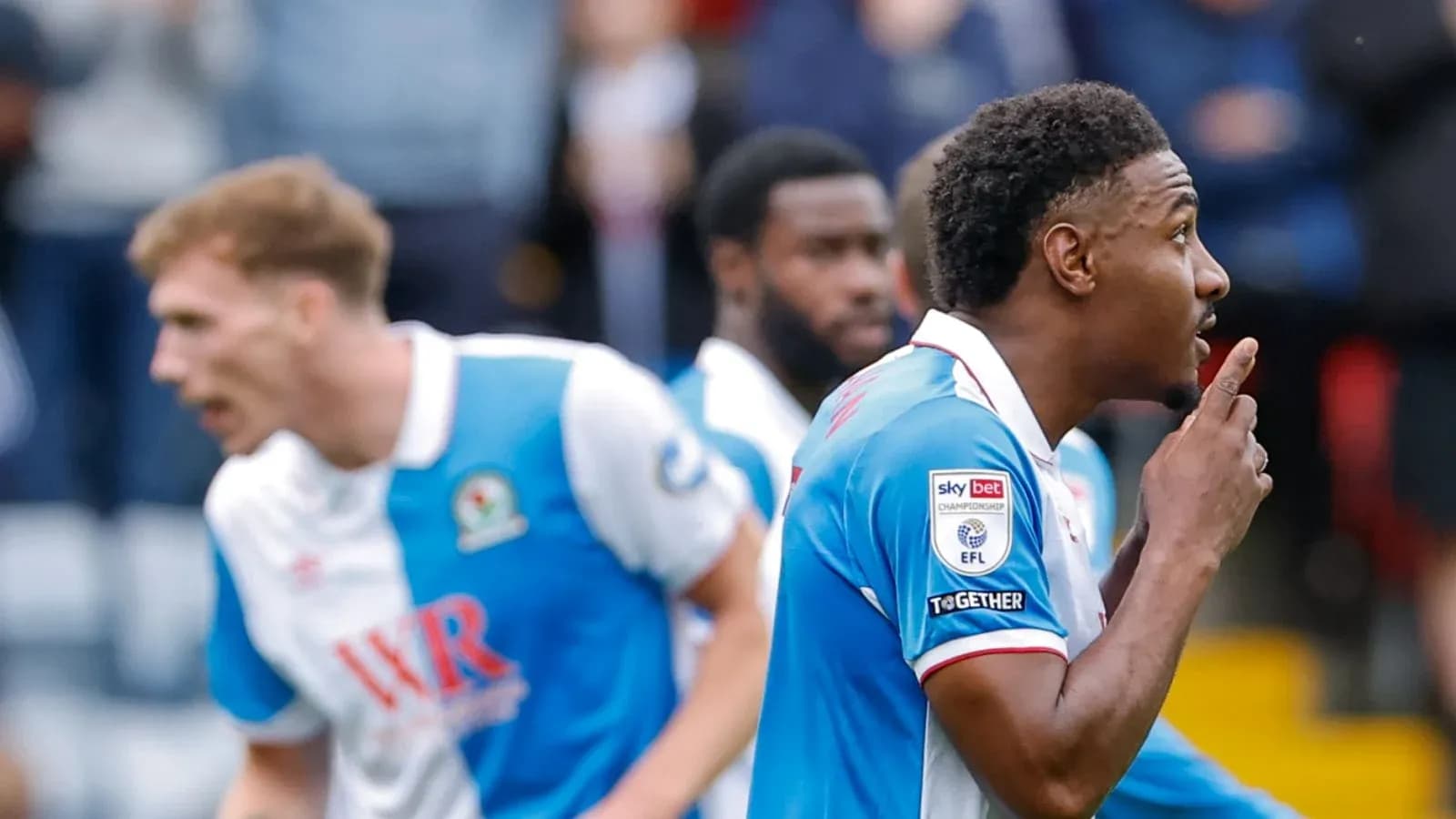 Player celebrating goal with shushing gesture during match Player celebrating goal with shushing gesture during match