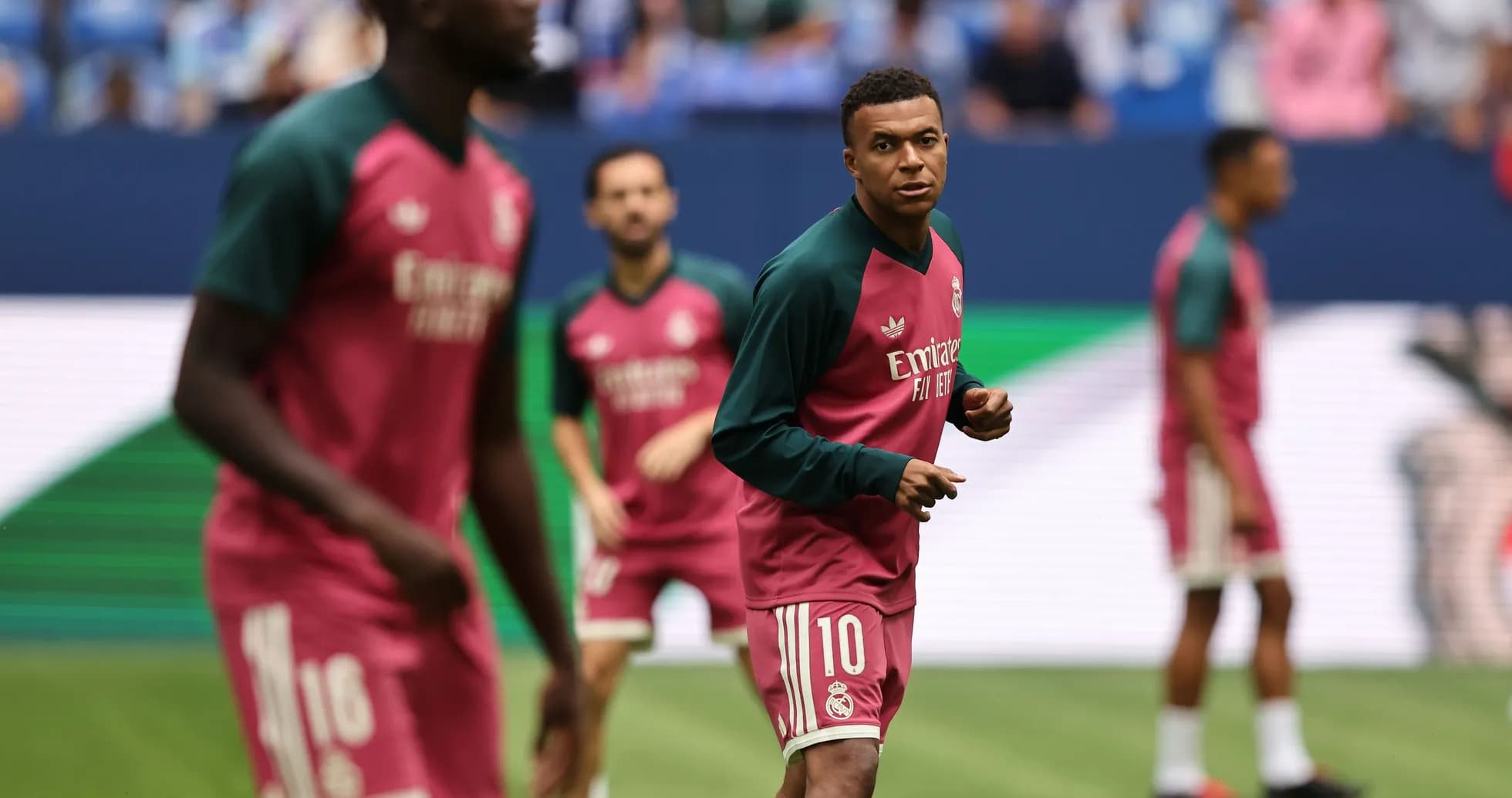 Players warming up in training kits before match Players warming up in training kits before match