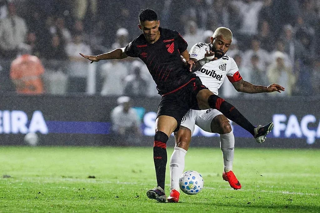 Player challenging for the ball during rainy match Player challenging for the ball during rainy match