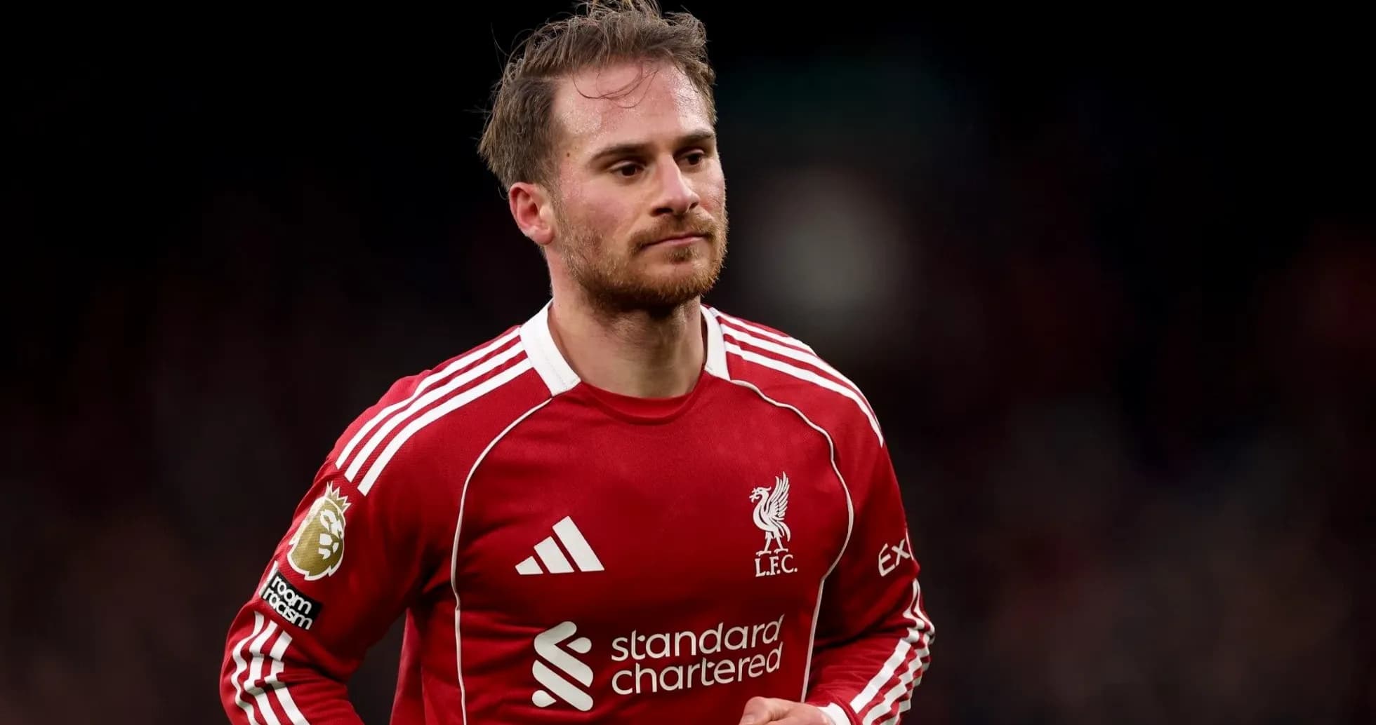 Player in Liverpool FC kit walking on the pitch Player in Liverpool FC kit walking on the pitch