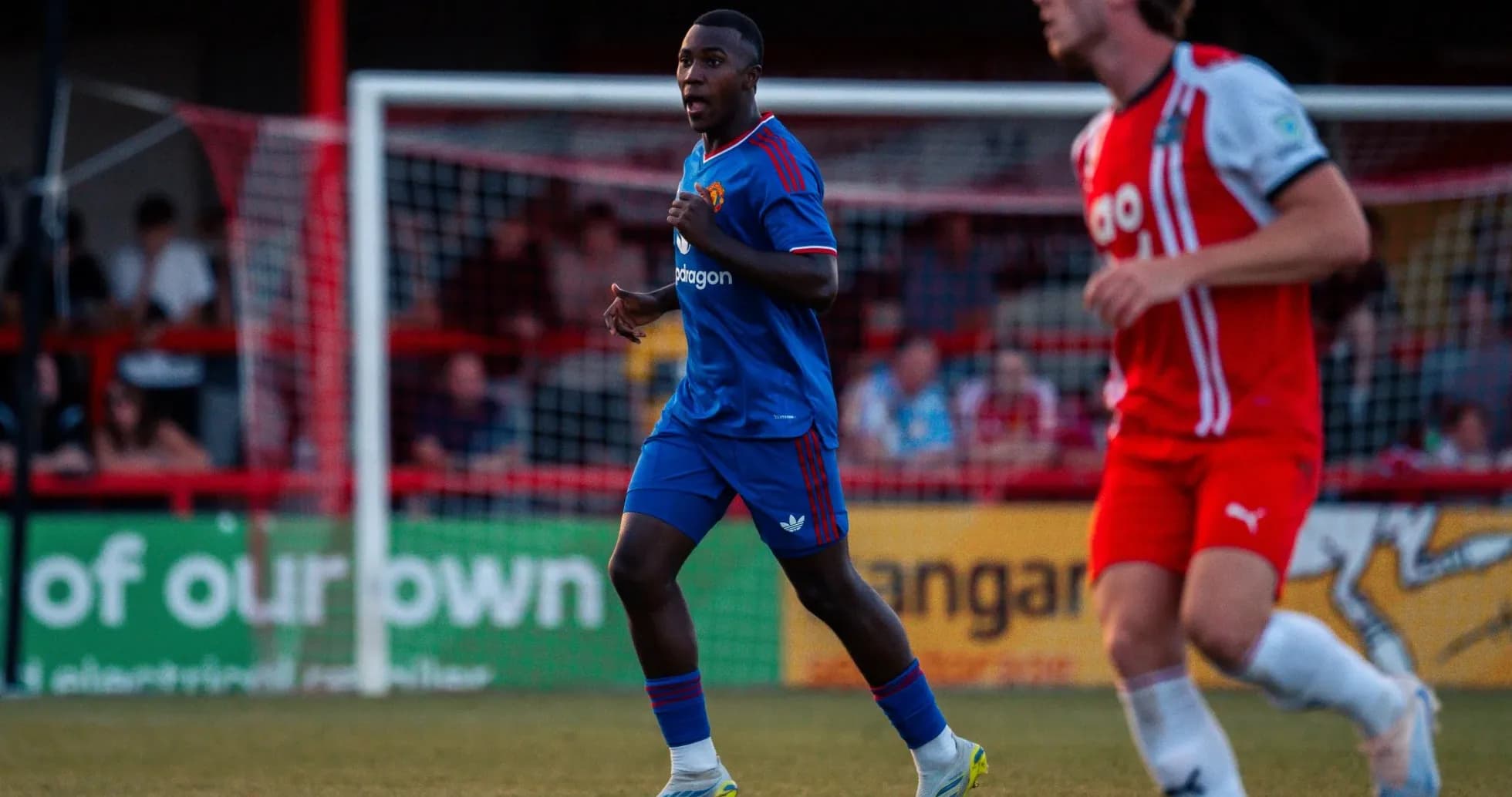 Player in blue jersey running on the field Player in blue jersey running on the field