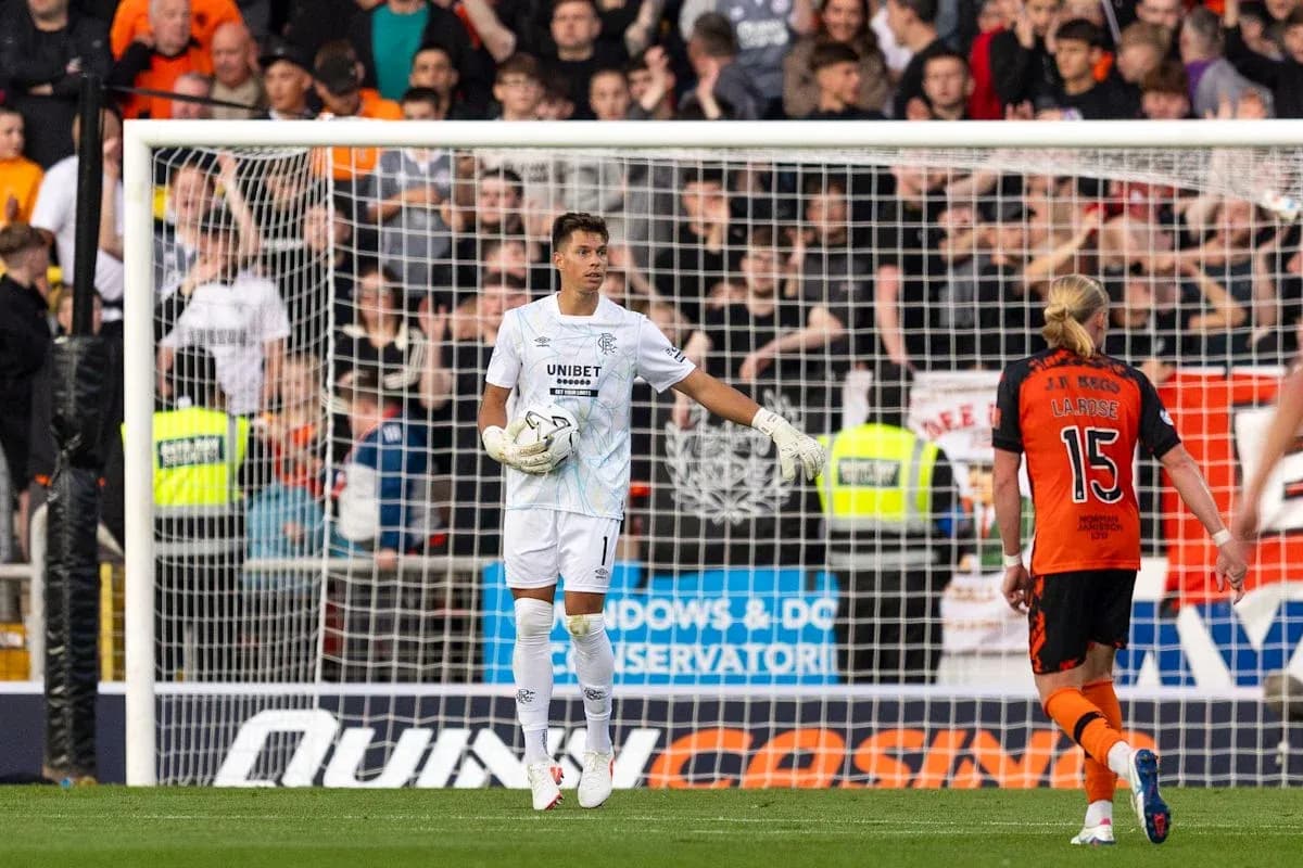 Goalkeeper in white kit gesturing during match Goalkeeper in white kit gesturing during match