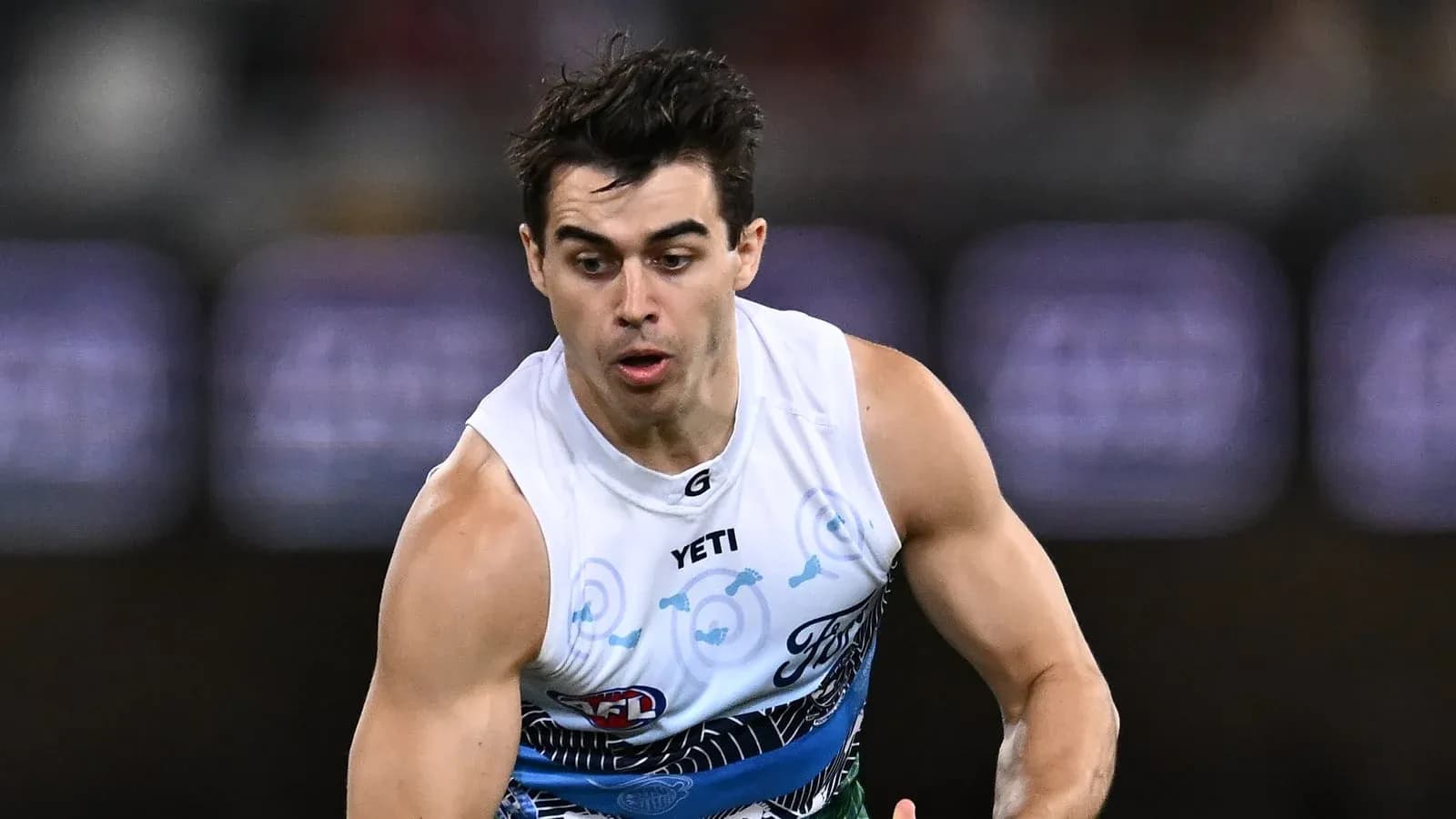 Player sprinting during an AFL match Player sprinting during an AFL match