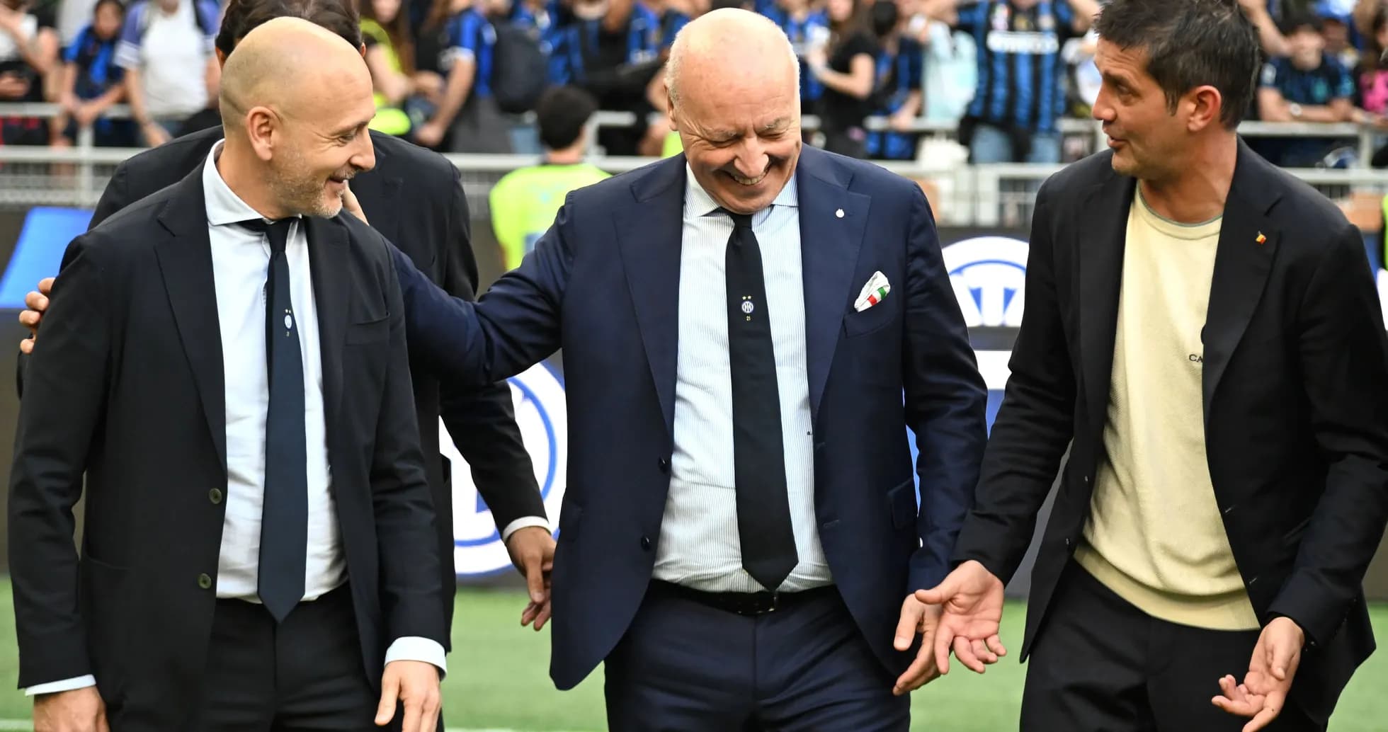 Three officials interacting on the pitch before match Three officials interacting on the pitch before match