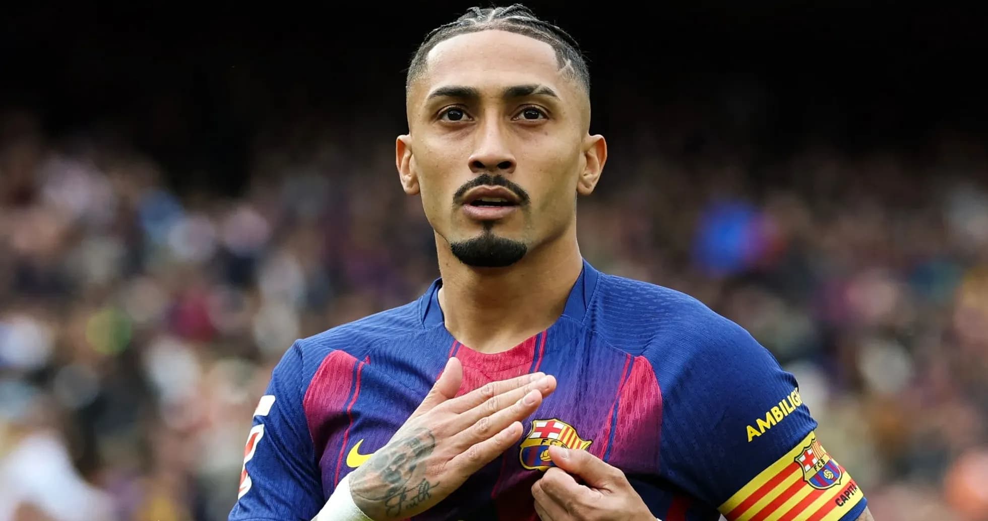 Player placing hand on FC Barcelona badge Player placing hand on FC Barcelona badge