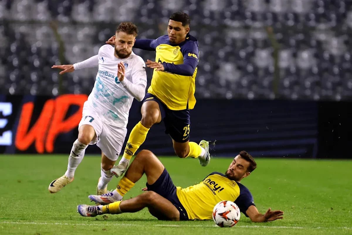 Player attempting to evade two opponents during match Player attempting to evade two opponents during match