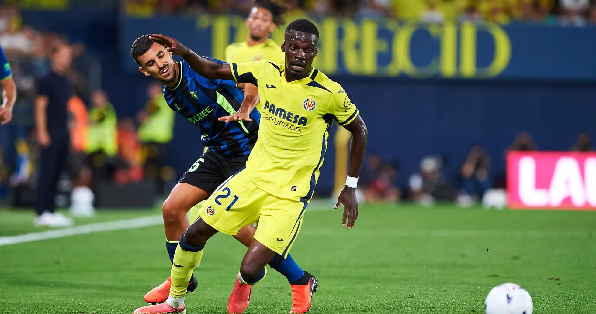 Player from Villarreal evading opponent during match Player from Villarreal evading opponent during match