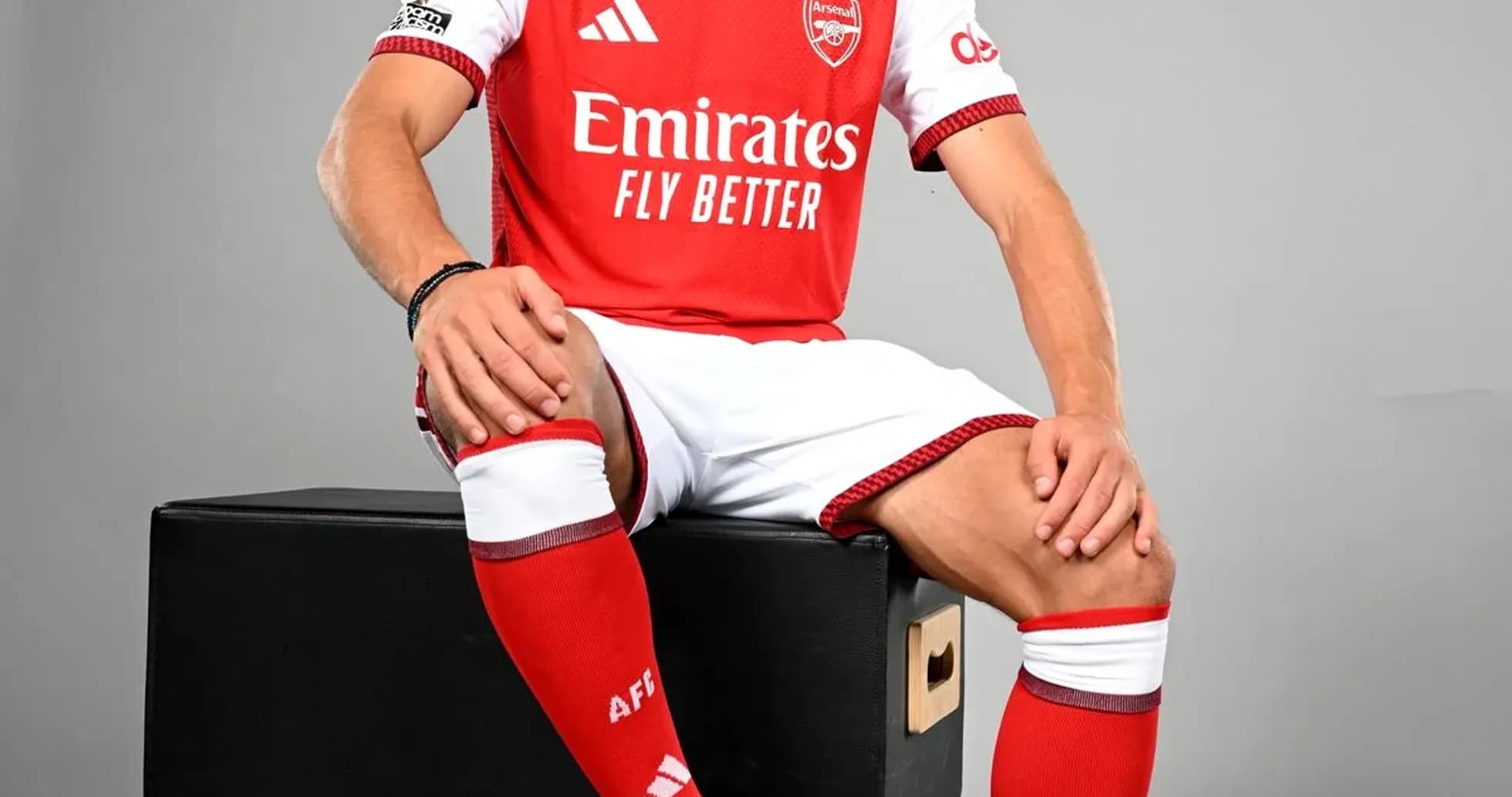 Player in Arsenal kit sitting on black box Player in Arsenal kit sitting on black box