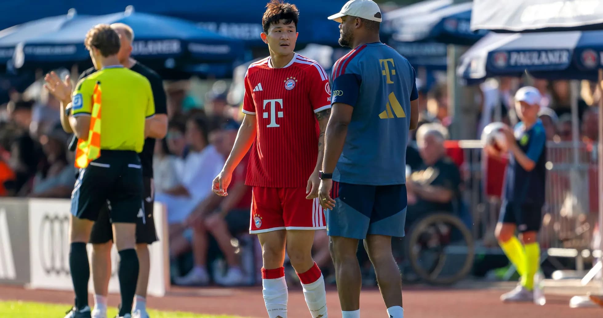 Bayern Munich player interacting with coach on sidelines Bayern Munich player interacting with coach on sidelines