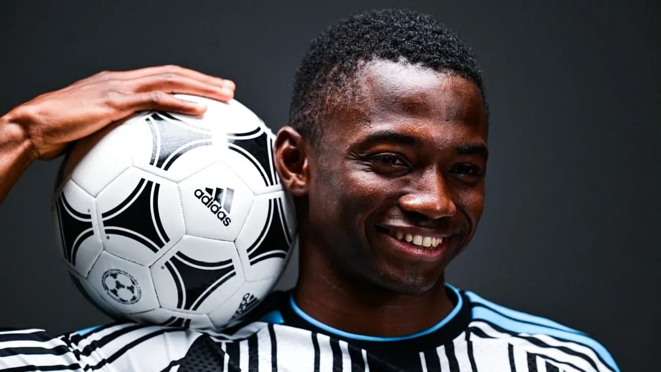 Player smiling while holding a soccer ball Player smiling while holding a soccer ball
