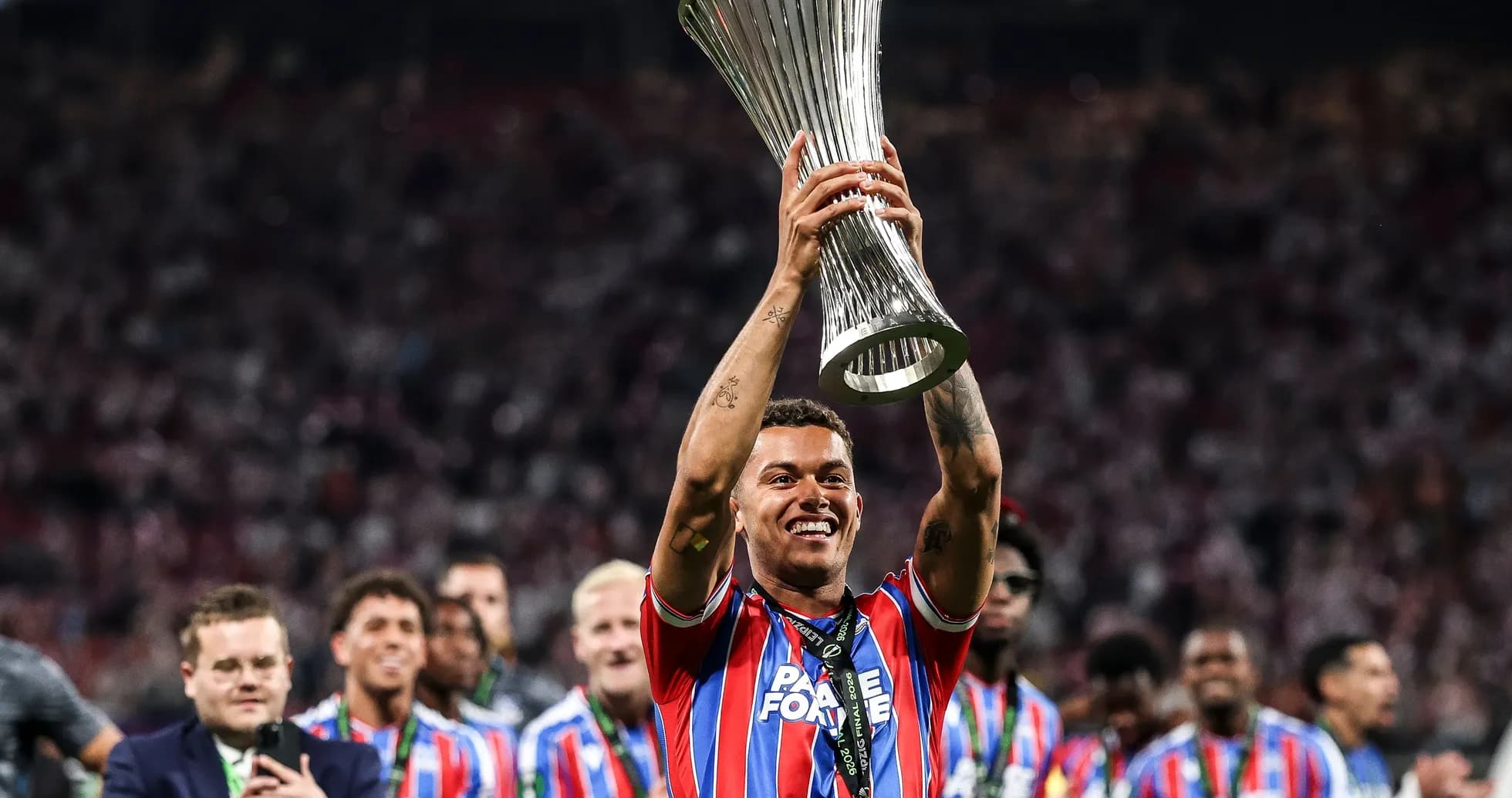 Player celebrating with trophy after winning match Player celebrating with trophy after winning match