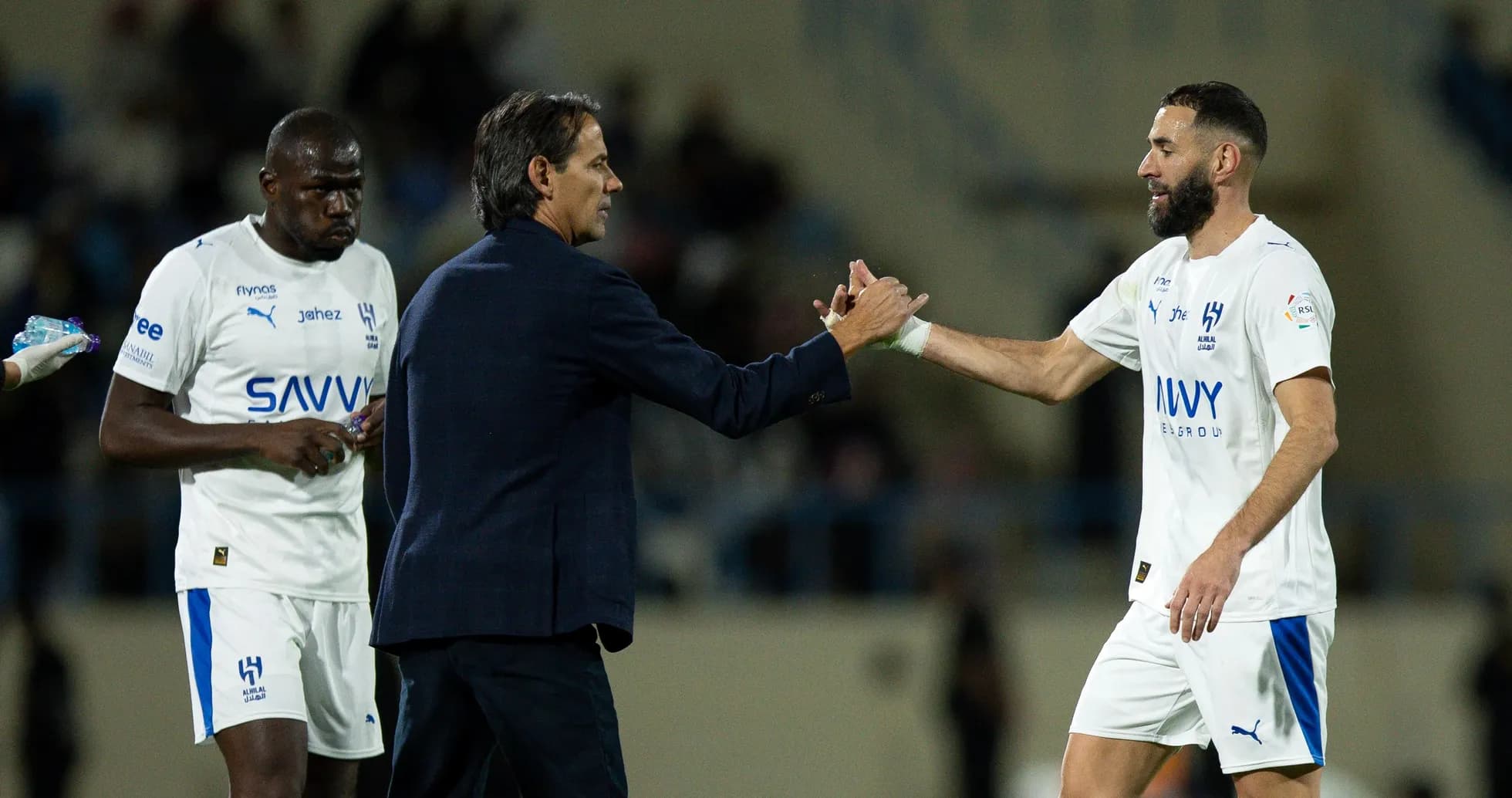 Coach shaking hands with player during match substitution Coach shaking hands with player during match substitution