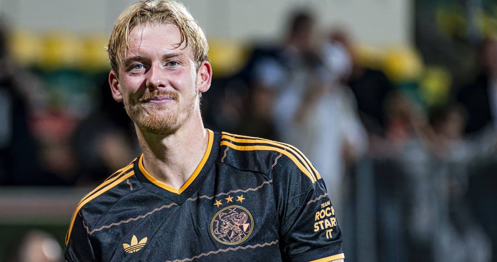 Player smiling in Ajax black jersey after match Player smiling in Ajax black jersey after match