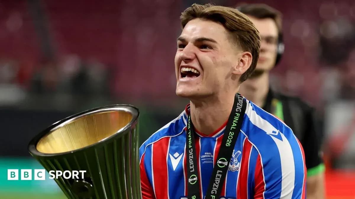 Player celebrating with trophy after match victory Player celebrating with trophy after match victory