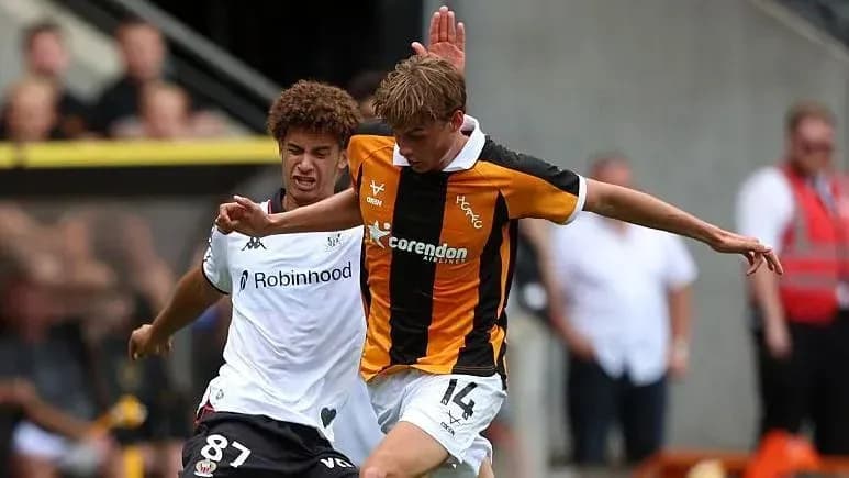 Player tackling opponent during a competitive match Player tackling opponent during a competitive match