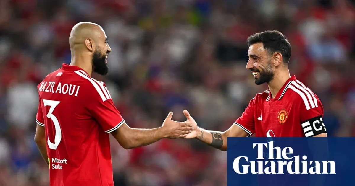 Two Manchester United players exchanging handshakes Two Manchester United players exchanging handshakes