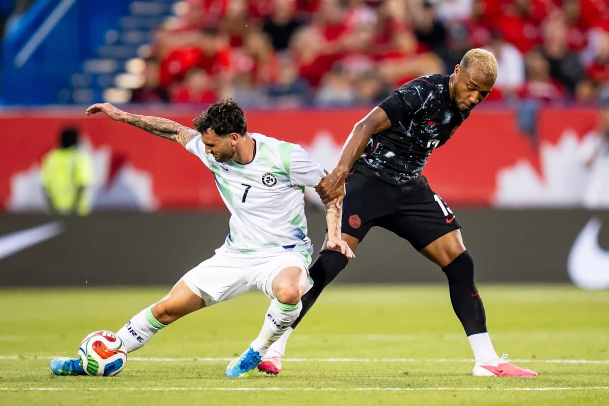 Two soccer players competing for the ball on field Two soccer players competing for the ball on field