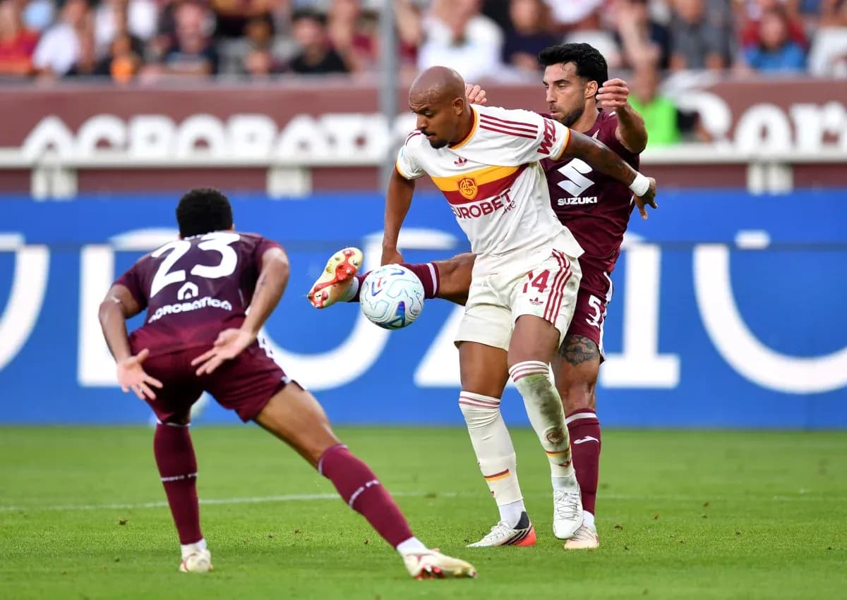 AS Roma player challenged by Torino defenders AS Roma player challenged by Torino defenders